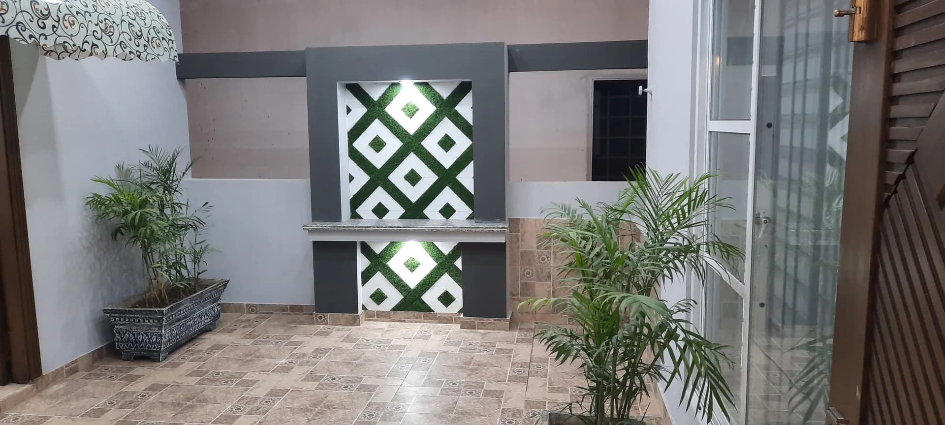 11 Indus — outdoor green accent wall, DC Colony Gujranwala