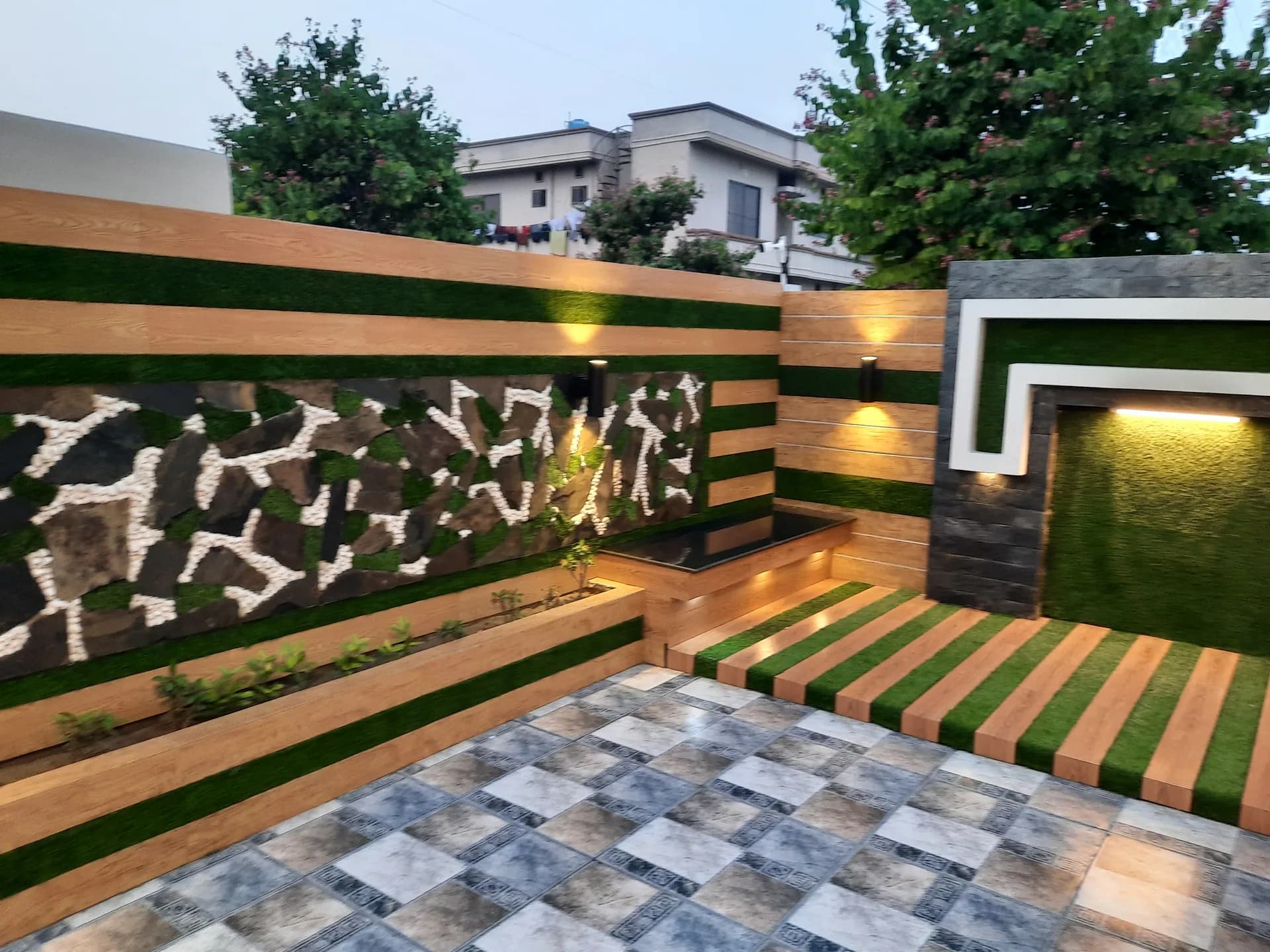 67 Jehlum — courtyard landscape wall, DC Colony Gujranwala
