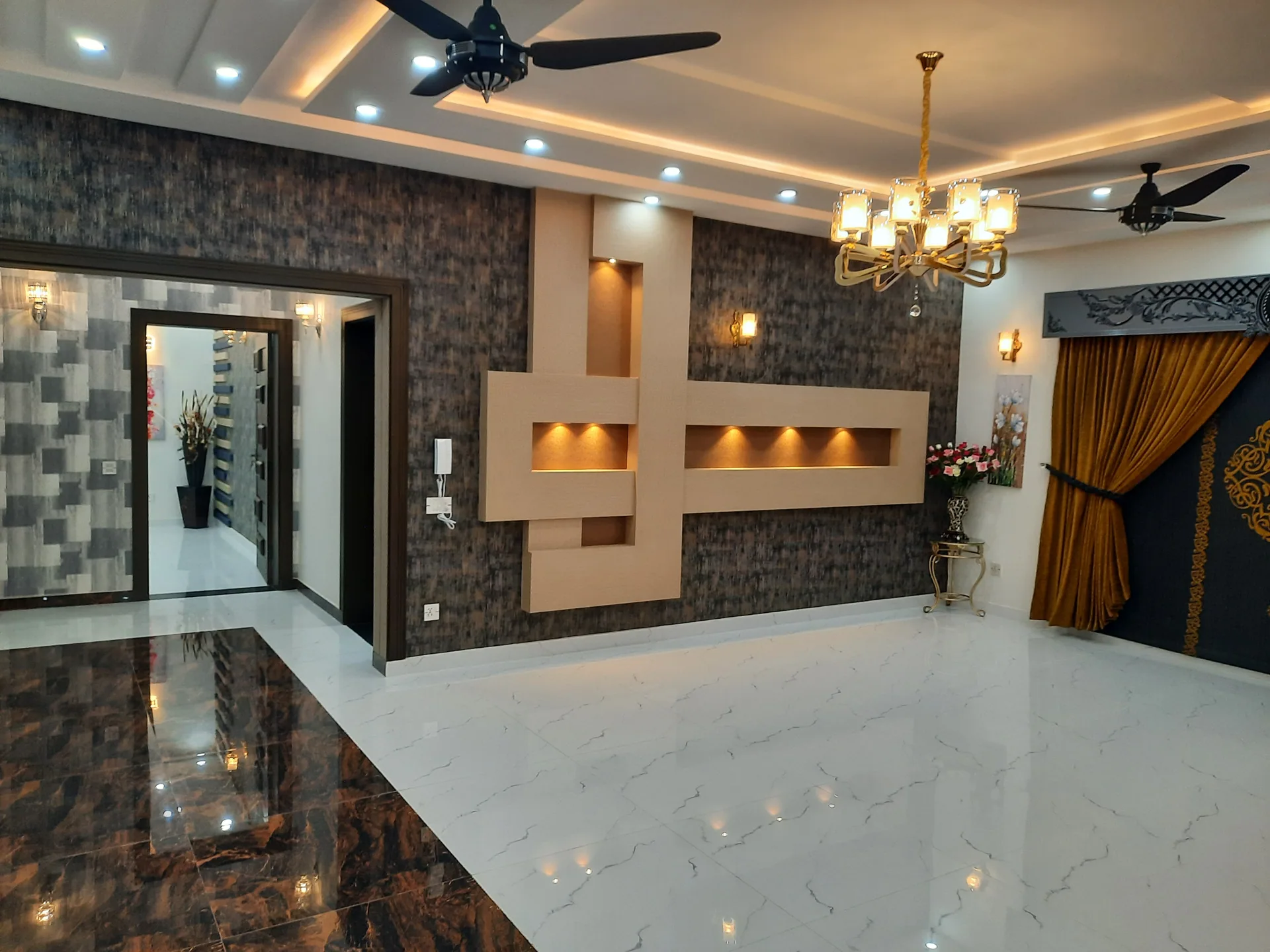 A refined Hayat Homes living room with dark feature wall